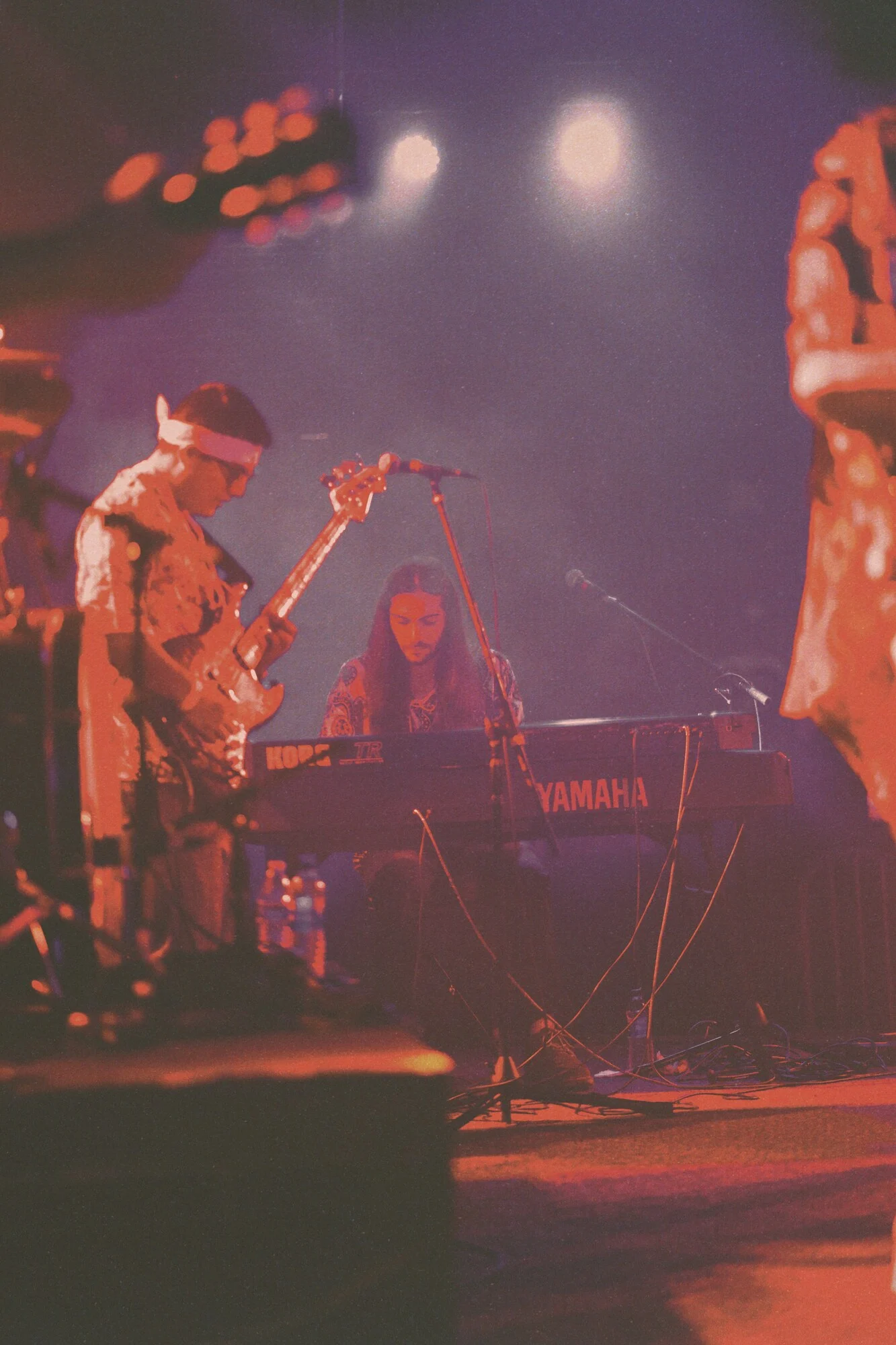 Musicians performing under stage lighting