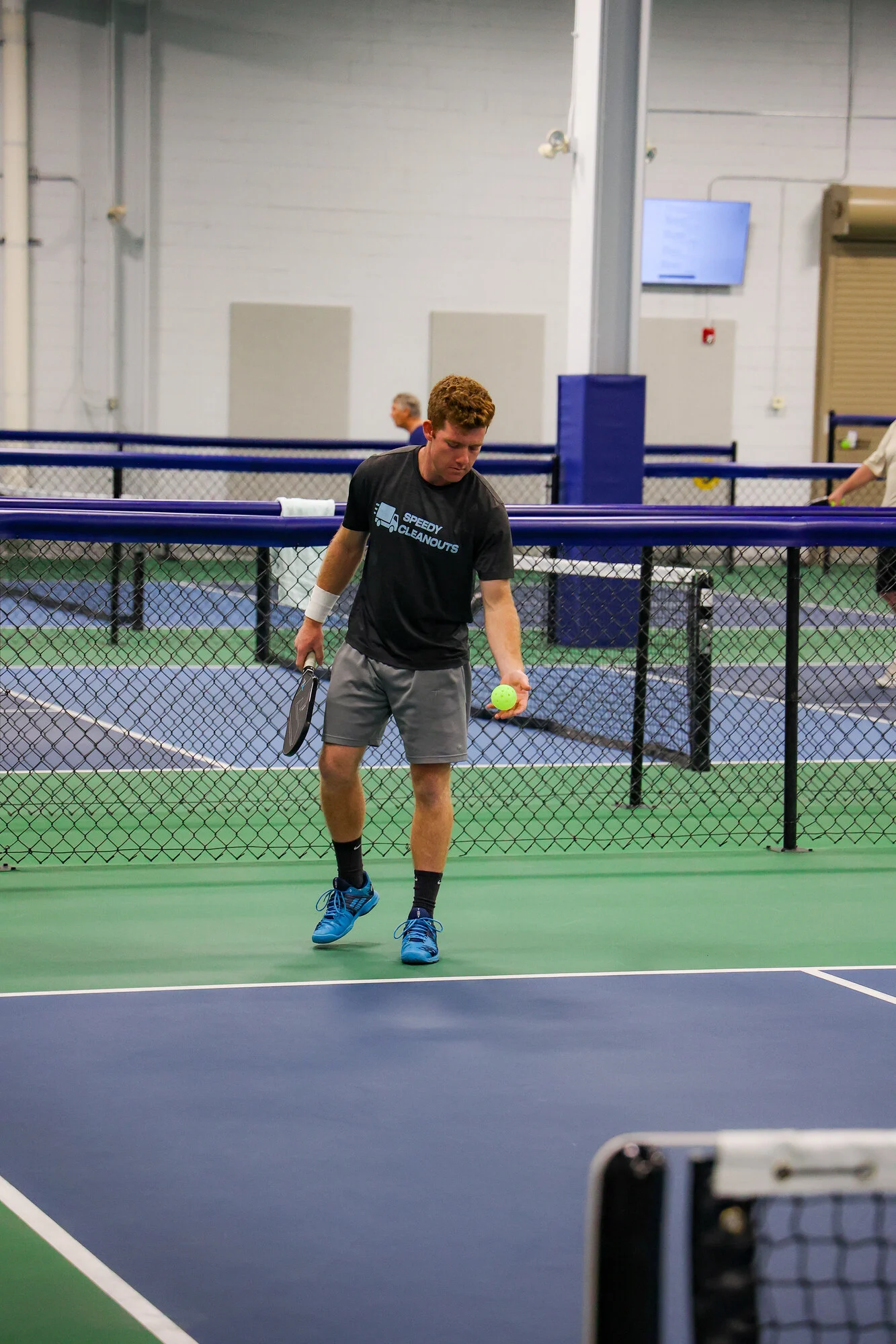 Pickleball player preparing a serve